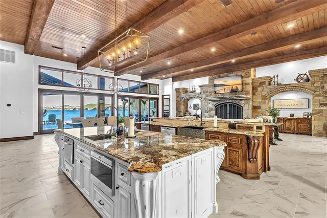 a view of a dining room with furniture a chandelier and wooden floor