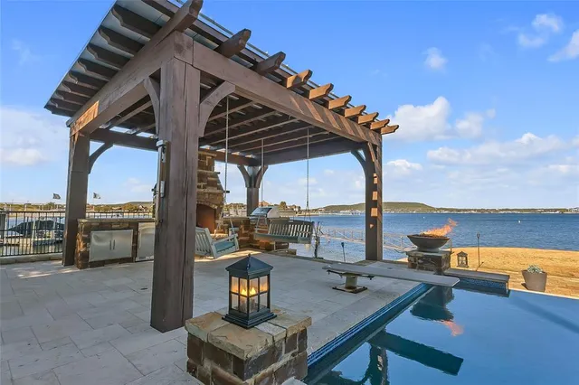 a kitchen with stainless steel appliances granite countertop a sink and a refrigerator