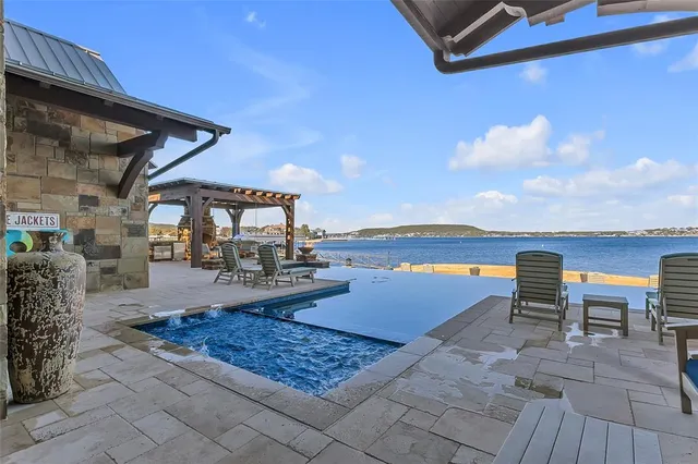 a living room with fireplace furniture and a large window
