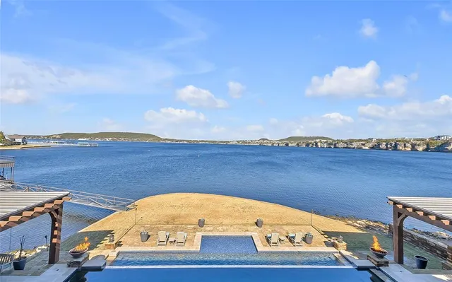 a view of a kitchen with stainless steel appliances granite countertop a sink and cabinets