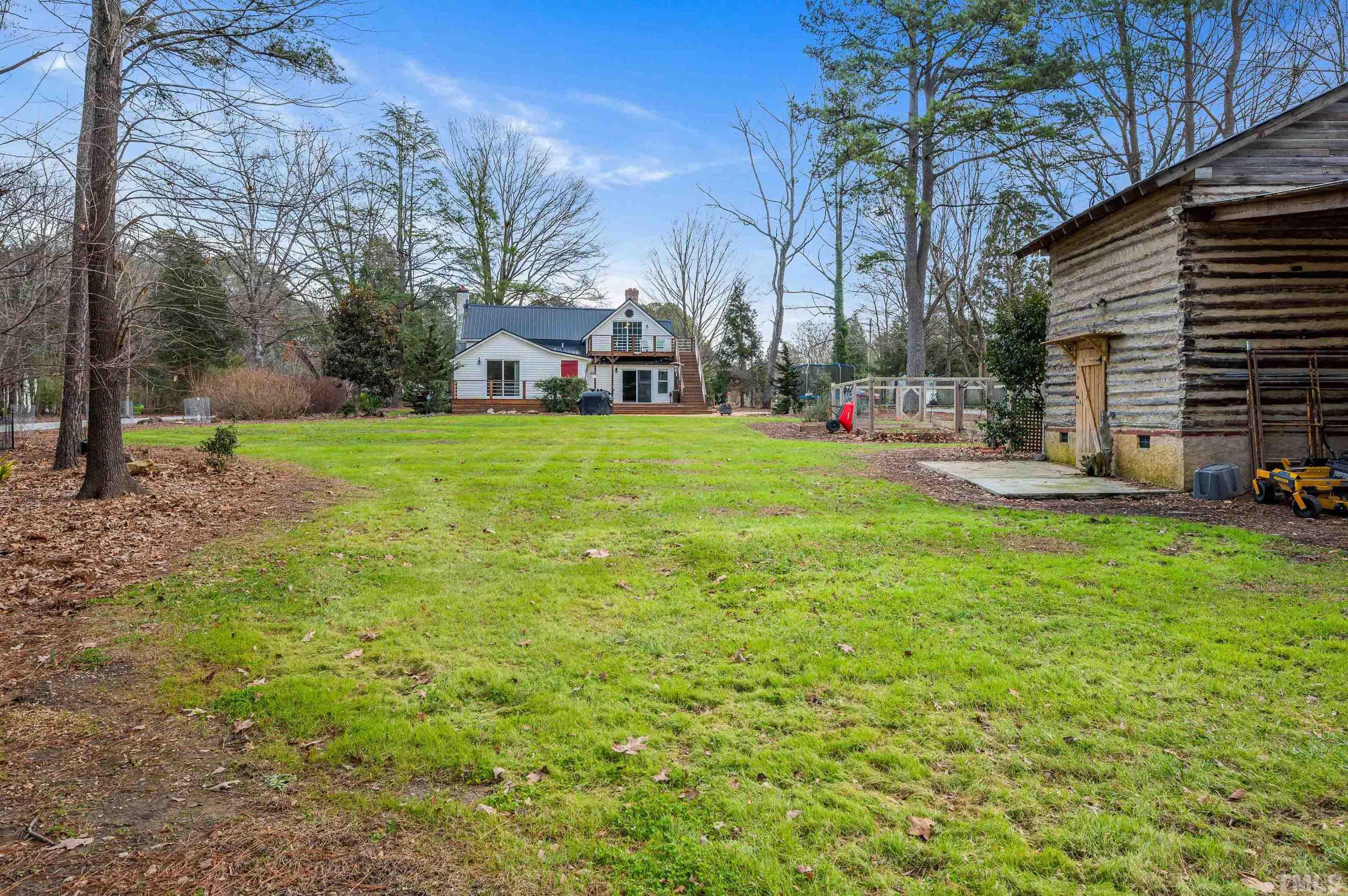 10601 Six Forks Road Raleigh, NC 27614 - Photo 3 of 36 a backyard of a house with table and chairs