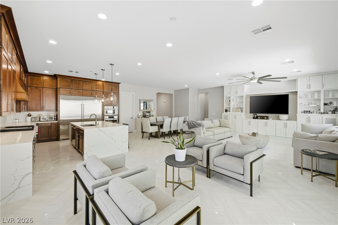 45 Garibaldi Way Henderson, NV 89011 - Photo 71 of 74 An open floorplan seamlessly connects the kitchen, dining, and living areas for fluid entertaining.
