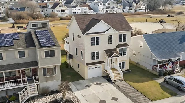 an aerial view of a house with a yard