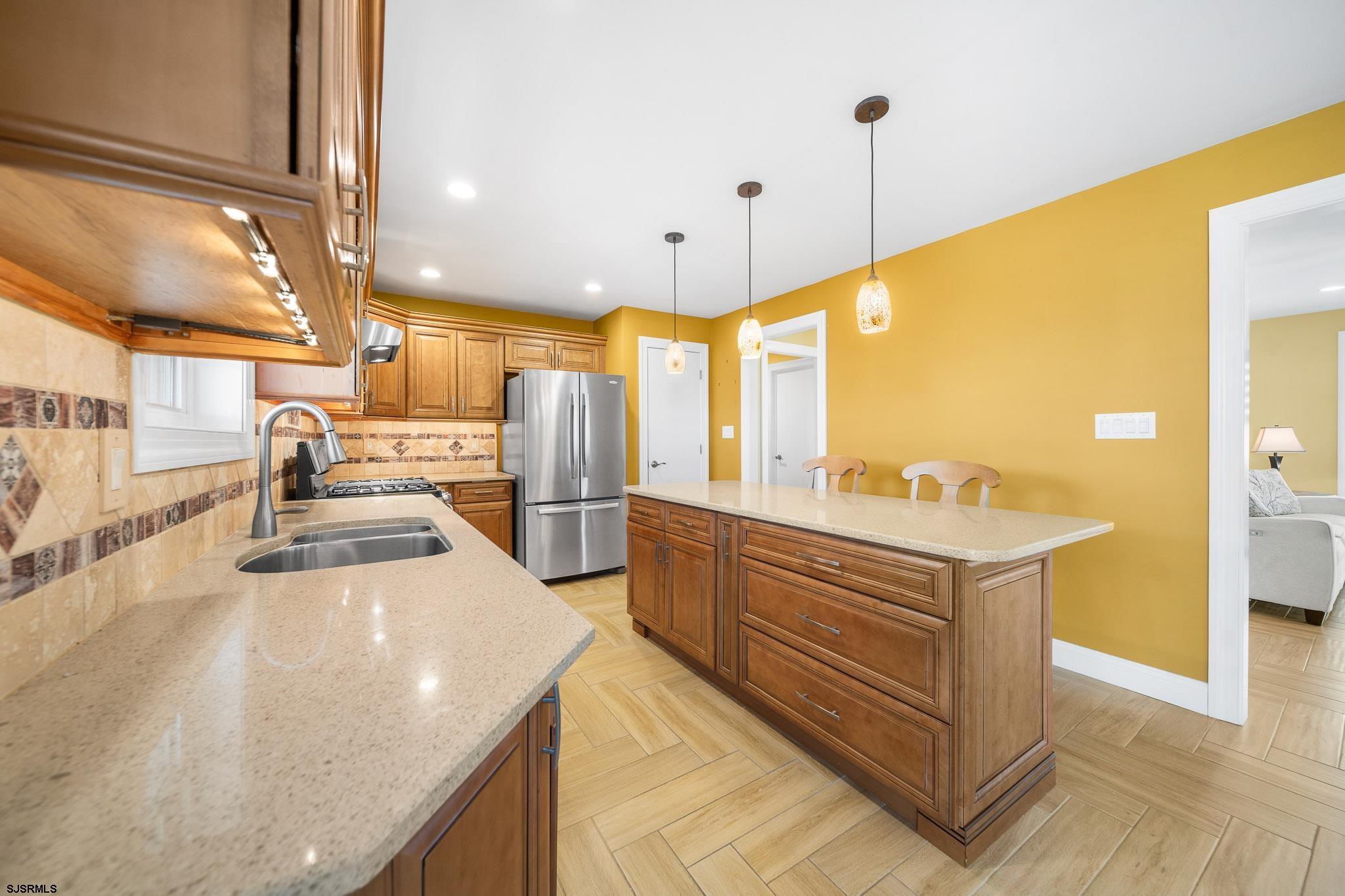 9 Cummings Place Brigantine, NJ 08203 - Photo 11 of 39 a kitchen with stainless steel appliances a stove a sink and a refrigerator