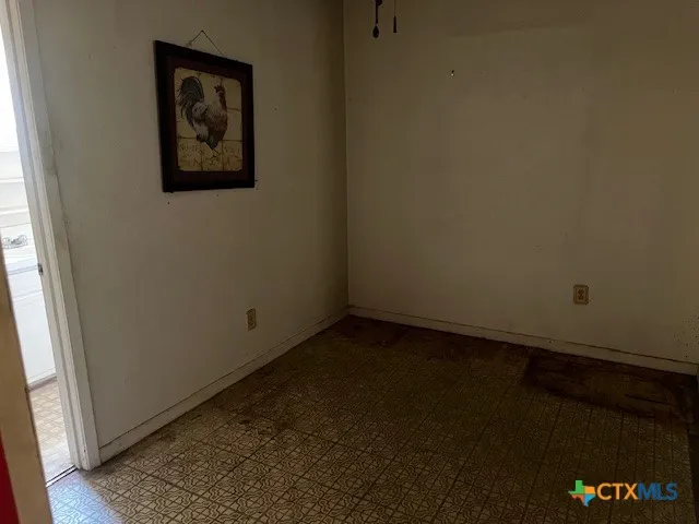 a view of empty room with windows and fan