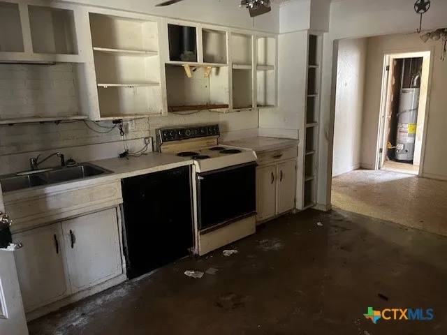 a kitchen with a sink and a stove top oven