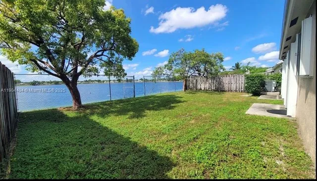 a view of a backyard with large tree