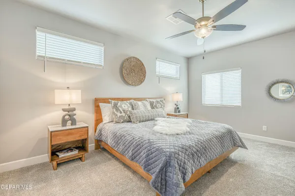 a bedroom with a bed and chandelier