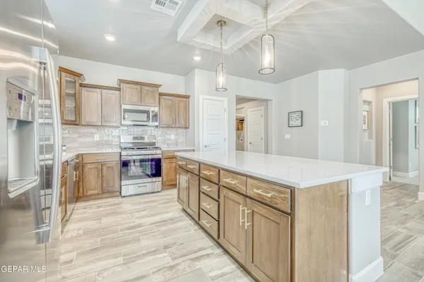 a kitchen with granite countertop cabinets stainless steel appliances and a counter space