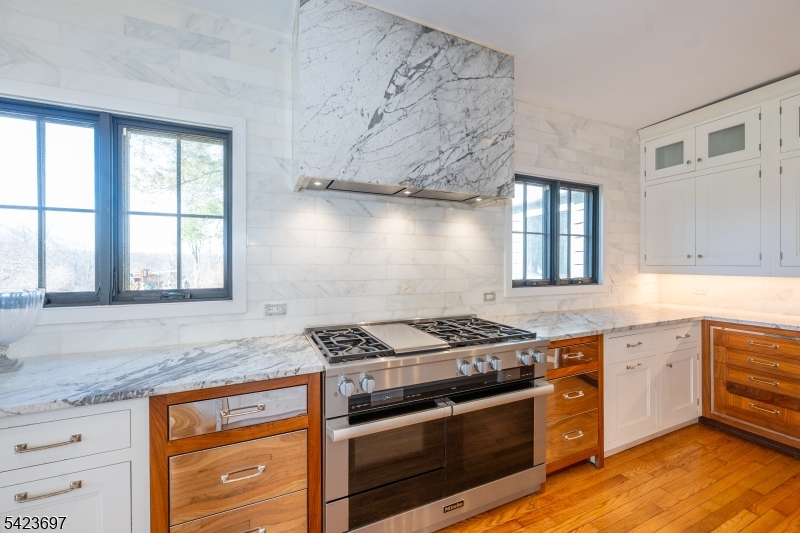 45 Village Road New Vernon, NJ 07976 - Photo 13 of 49 a kitchen with stainless steel appliances granite countertop a stove and a sink