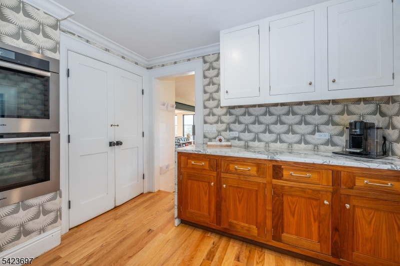 45 Village Road New Vernon, NJ 07976 - Photo 15 of 49 a kitchen with stainless steel appliances granite countertop a sink a stove a refrigerator and cabinets
