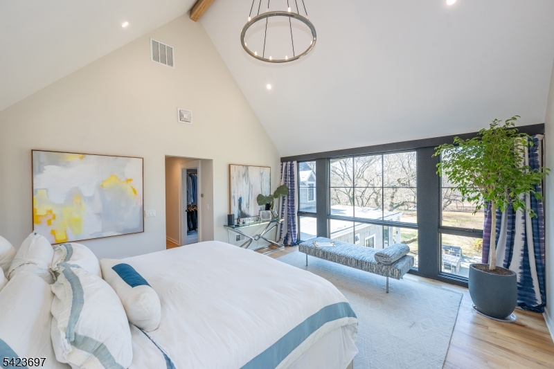 45 Village Road New Vernon, NJ 07976 - Photo 20 of 49 a bedroom with a large bed and a large window