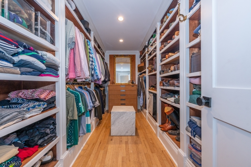 45 Village Road New Vernon, NJ 07976 - Photo 24 of 49 a view of walk in closet with clothes and shoes