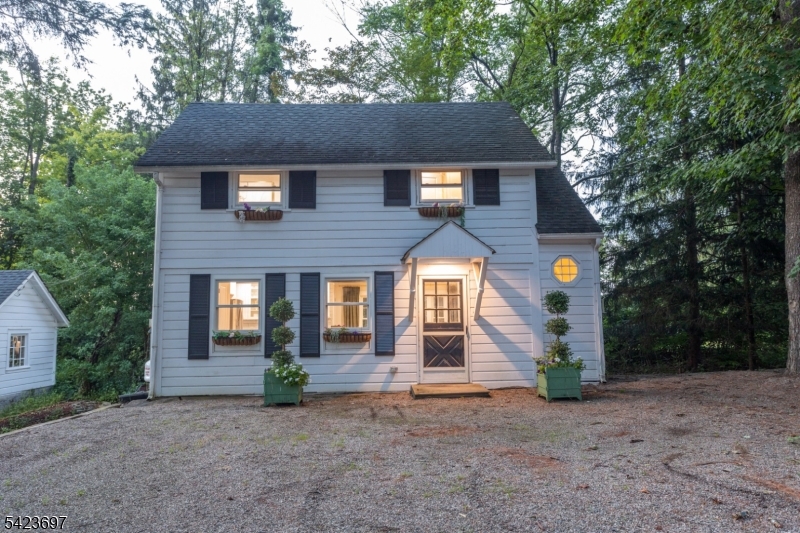 45 Village Road New Vernon, NJ 07976 - Photo 45 of 49 a front view of a house with garden
