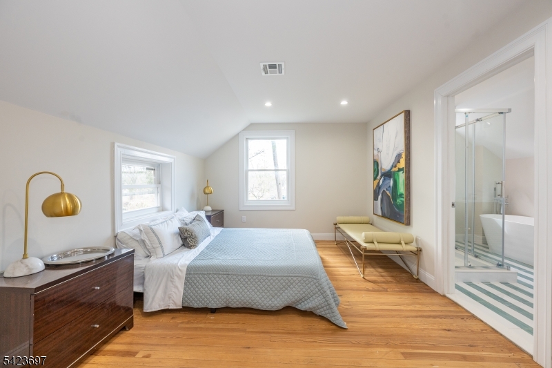 45 Village Road New Vernon, NJ 07976 - Photo 47 of 49 a spacious bedroom with a large bed and a dresser