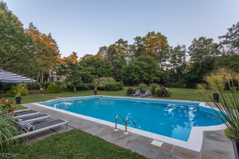 45 Village Road New Vernon, NJ 07976 - Photo 5 of 49 a view of a swimming pool with a patio and a yard