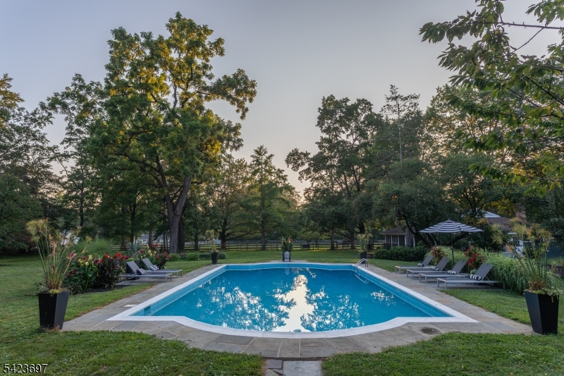45 Village Road New Vernon, NJ 07976 - Photo 6 of 49 a view of a swimming pool with a yard and sitting area