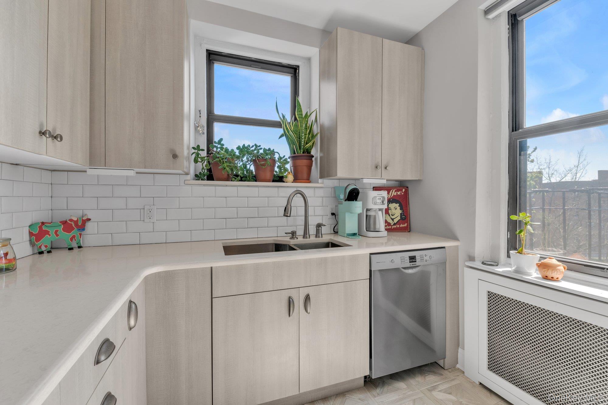 84-51 Beverly Road, Unit 6A Queens, NY 11415 - Photo 8 of 14 a kitchen with a sink cabinets and window