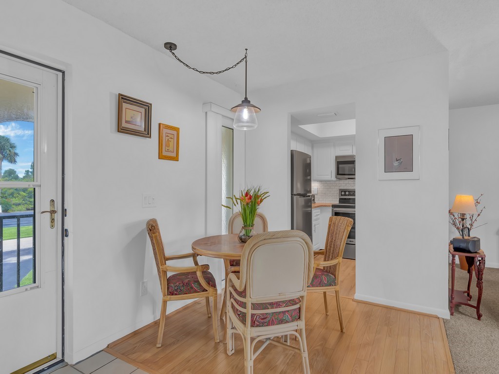1860 Robalo Drive, Unit 203A Vero Beach, FL 32960 - Photo 11 of 36 a dining room with furniture and window
