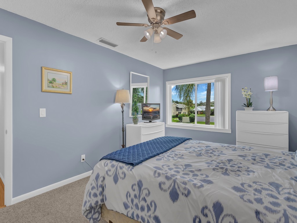1860 Robalo Drive, Unit 203A Vero Beach, FL 32960 - Photo 13 of 36 a bedroom with a large bed and a window