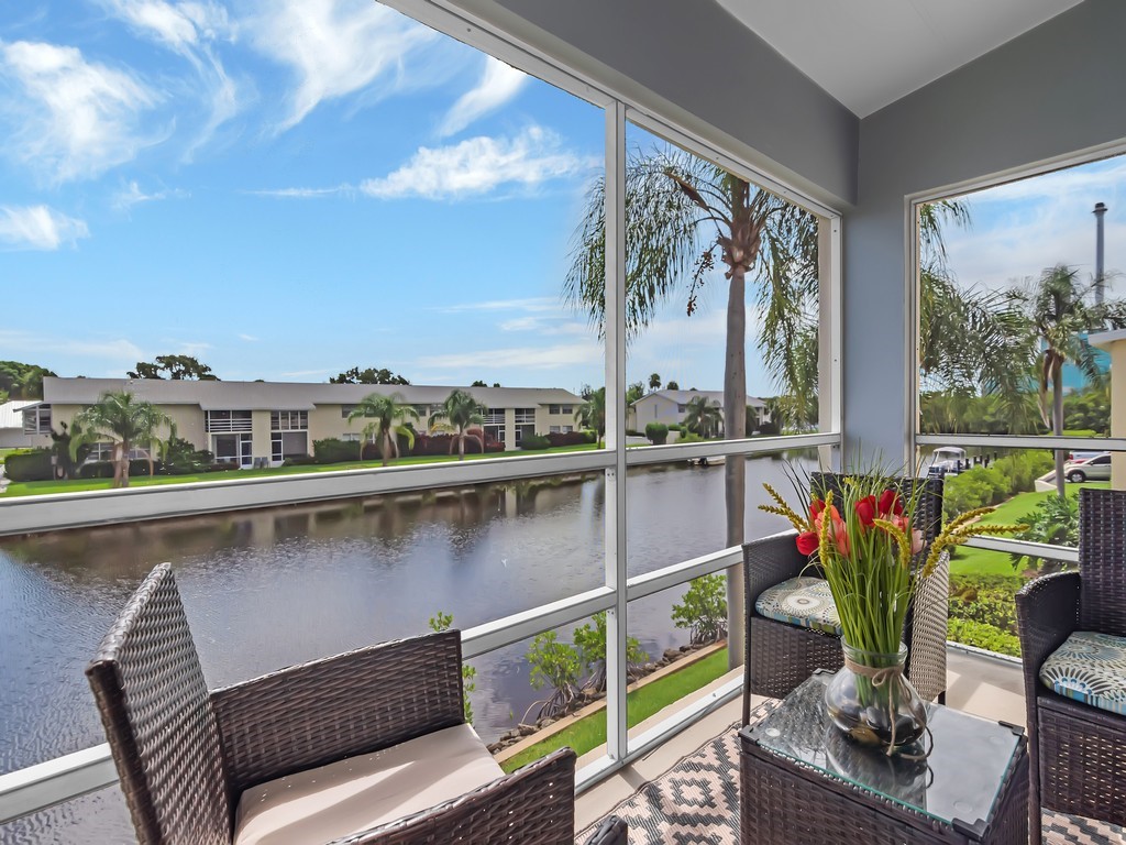 1860 Robalo Drive, Unit 203A Vero Beach, FL 32960 - Photo 2 of 36 a balcony with furniture and a potted plant