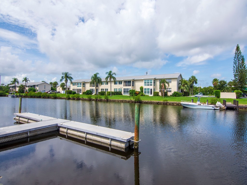 1860 Robalo Drive, Unit 203A Vero Beach, FL 32960 - Photo 21 of 36 a view of a lake with a terrace