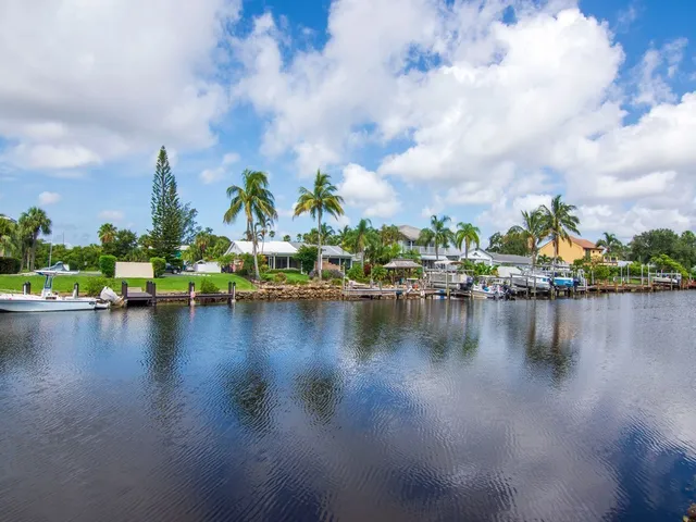 a view of a lake with boats and trees in the background