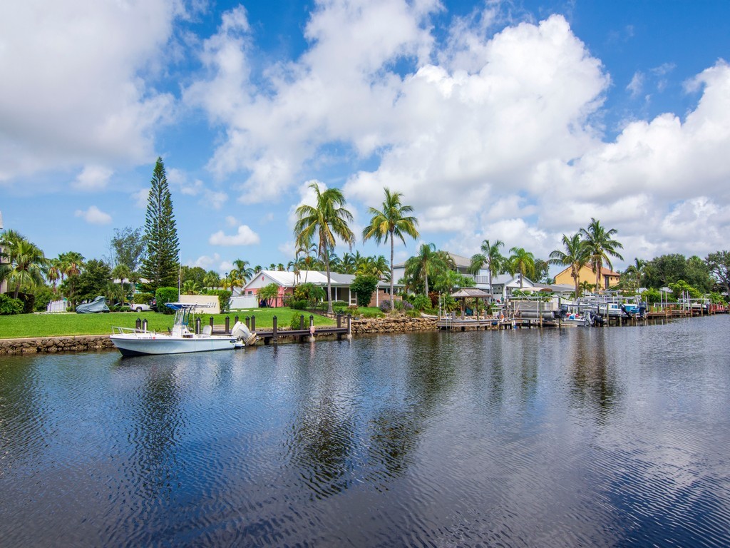 1860 Robalo Drive, Unit 203A Vero Beach, FL 32960 - Photo 23 of 36 a view of a lake with houses