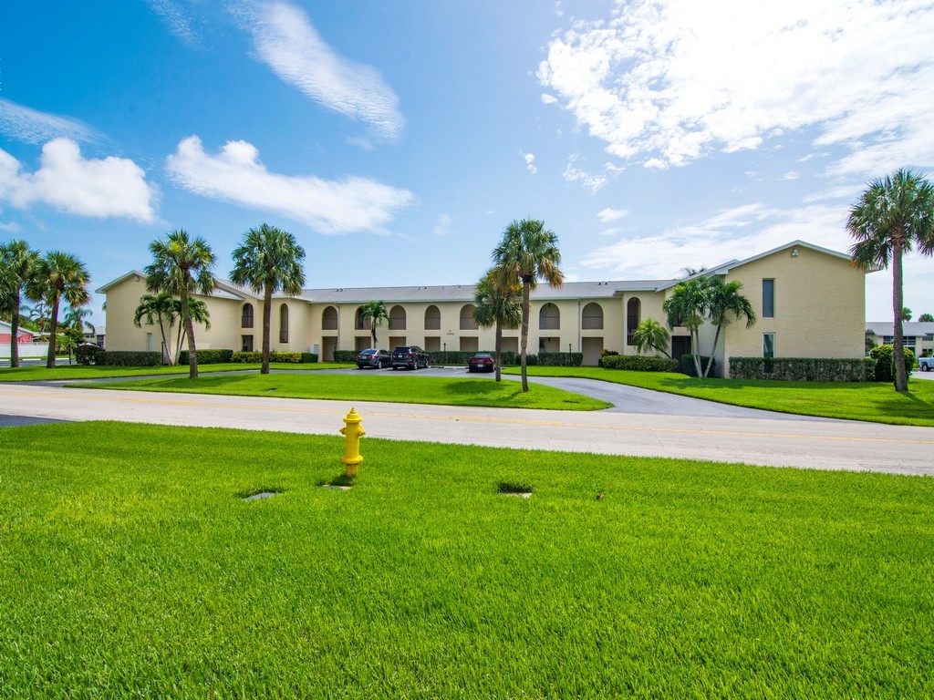 1860 Robalo Drive, Unit 203A Vero Beach, FL 32960 - Photo 25 of 36 a view of yard with swimming pool and green space