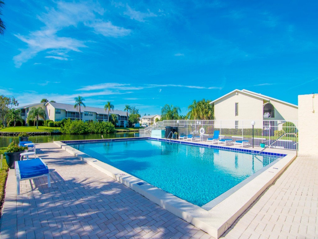 1860 Robalo Drive, Unit 203A Vero Beach, FL 32960 - Photo 27 of 36 a view of swimming pool with outdoor seating and yard
