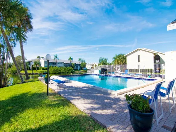 a view of swimming pool with outdoor seating and plants