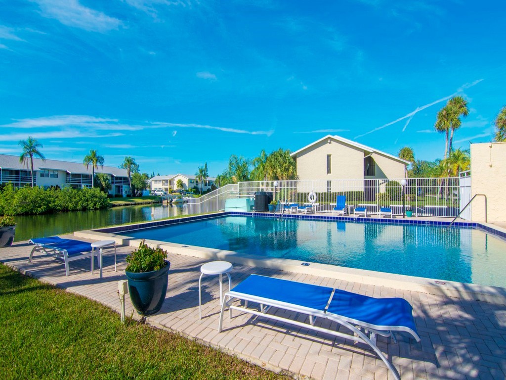 1860 Robalo Drive, Unit 203A Vero Beach, FL 32960 - Photo 29 of 36 a view of swimming pool with outdoor seating and plants
