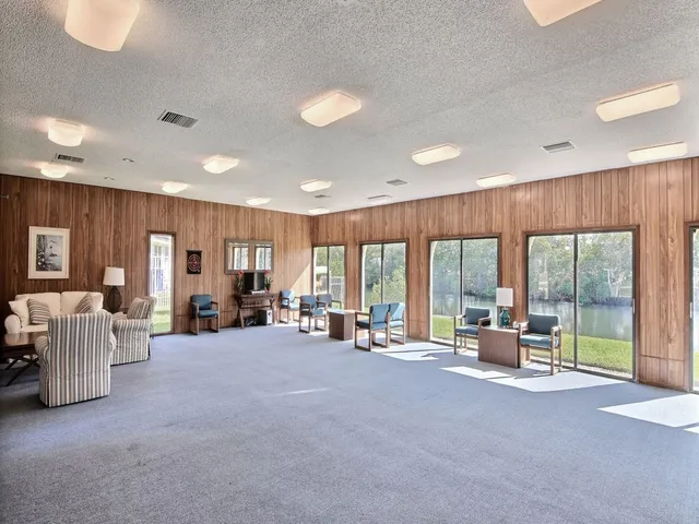a living room with furniture and large windows