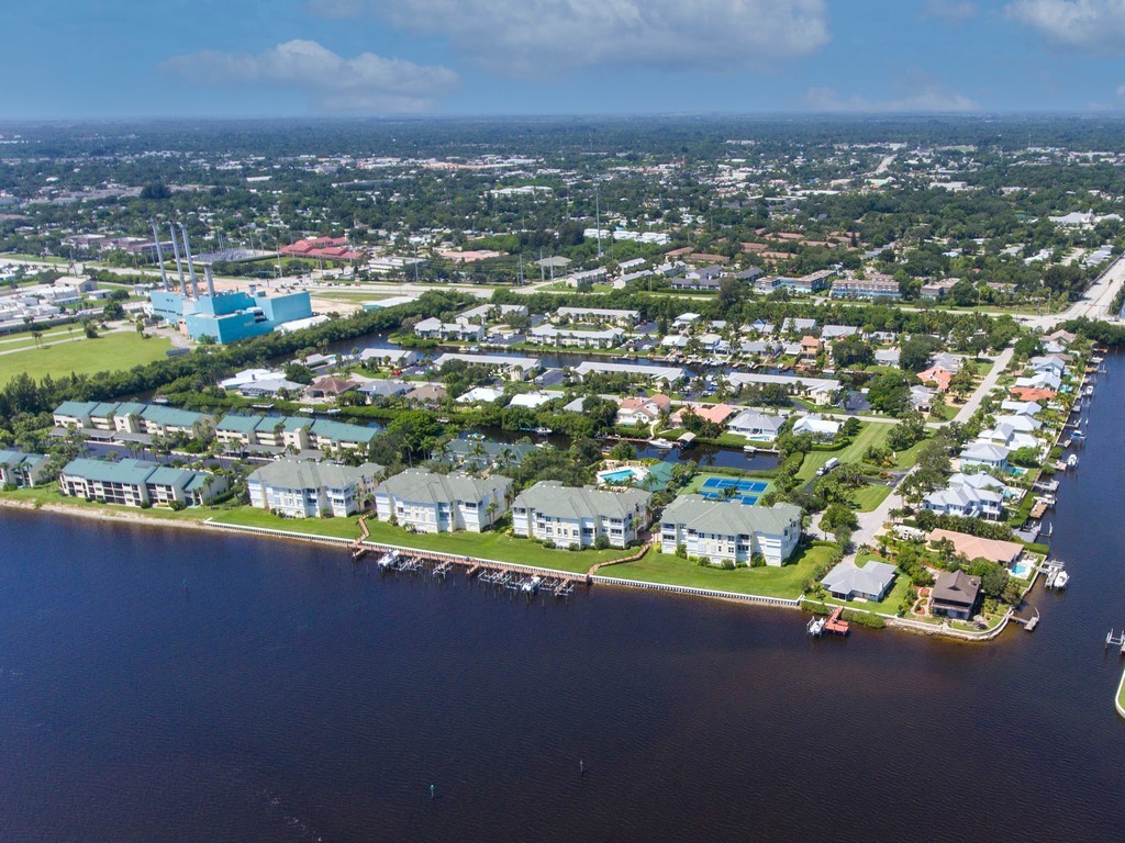 1860 Robalo Drive, Unit 203A Vero Beach, FL 32960 - Photo 35 of 36 an aerial view of a city with lots of residential buildings ocean and mountain view in back