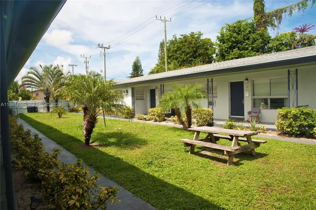 a view of a house with backyard sitting area and garden