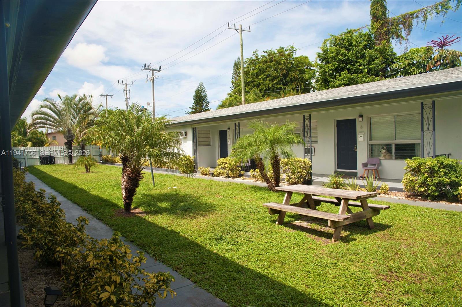 a view of a house with backyard sitting area and garden