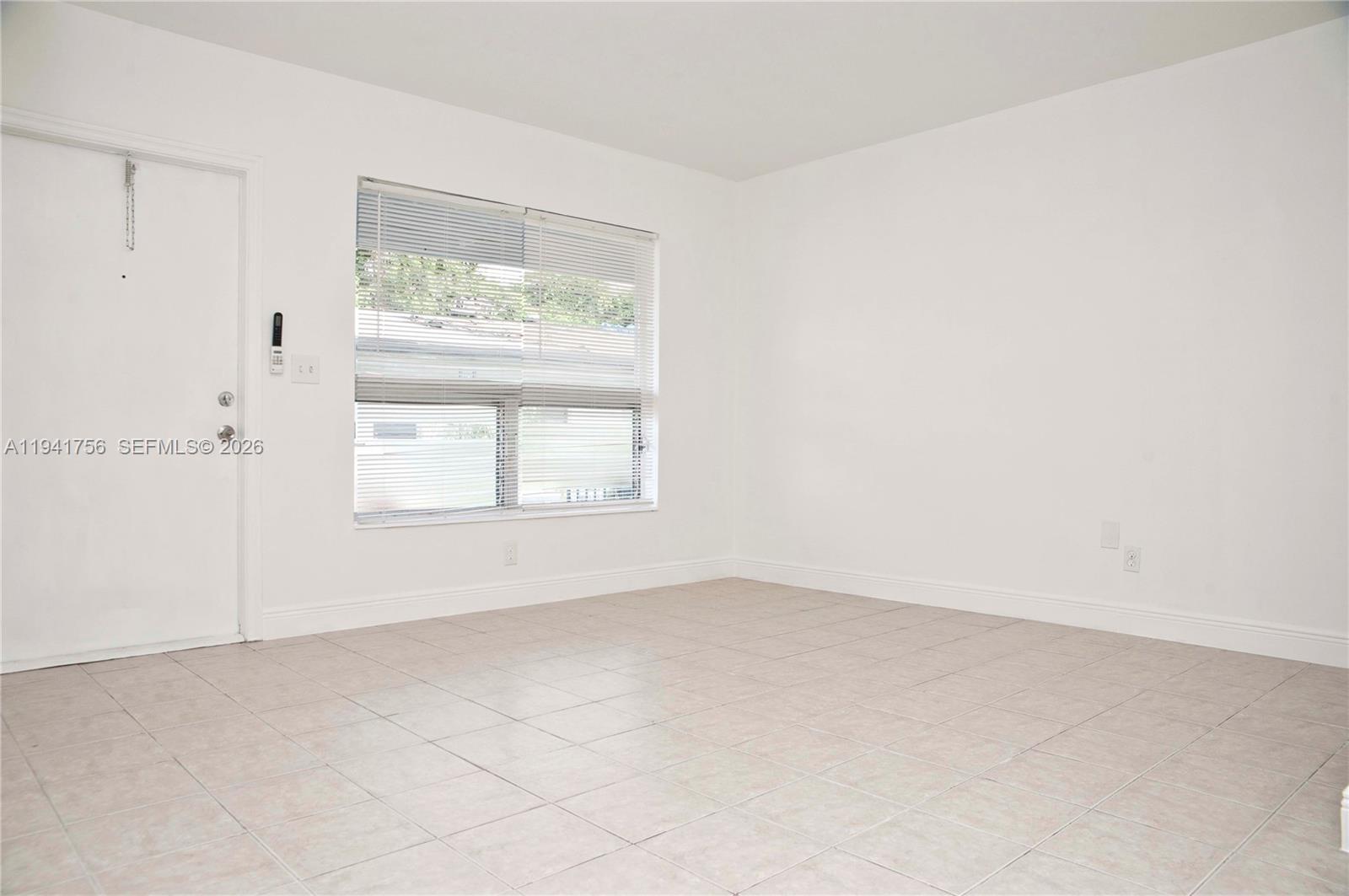2206 Fillmore Street, Unit 3 Hollywood, FL 33020 - Photo 4 of 12 an empty room with windows