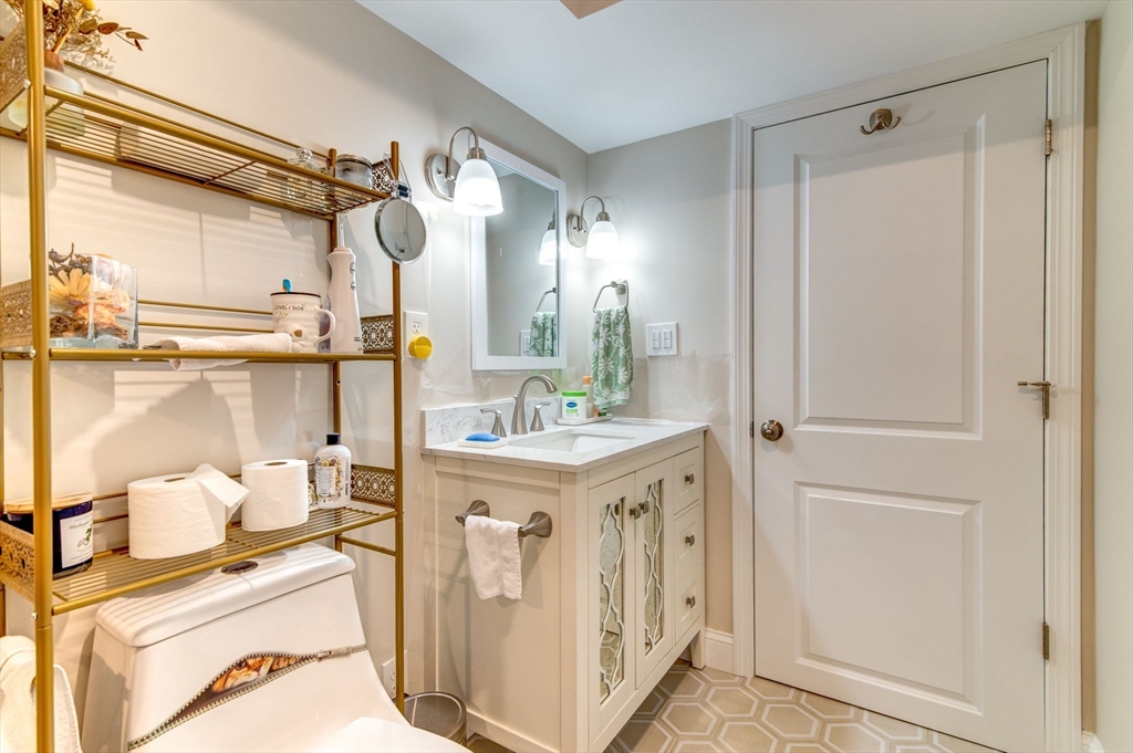 51 Tamarack Road Dracut, MA 01826 - Photo 31 of 39 a view of a bathroom with a sink and mirror