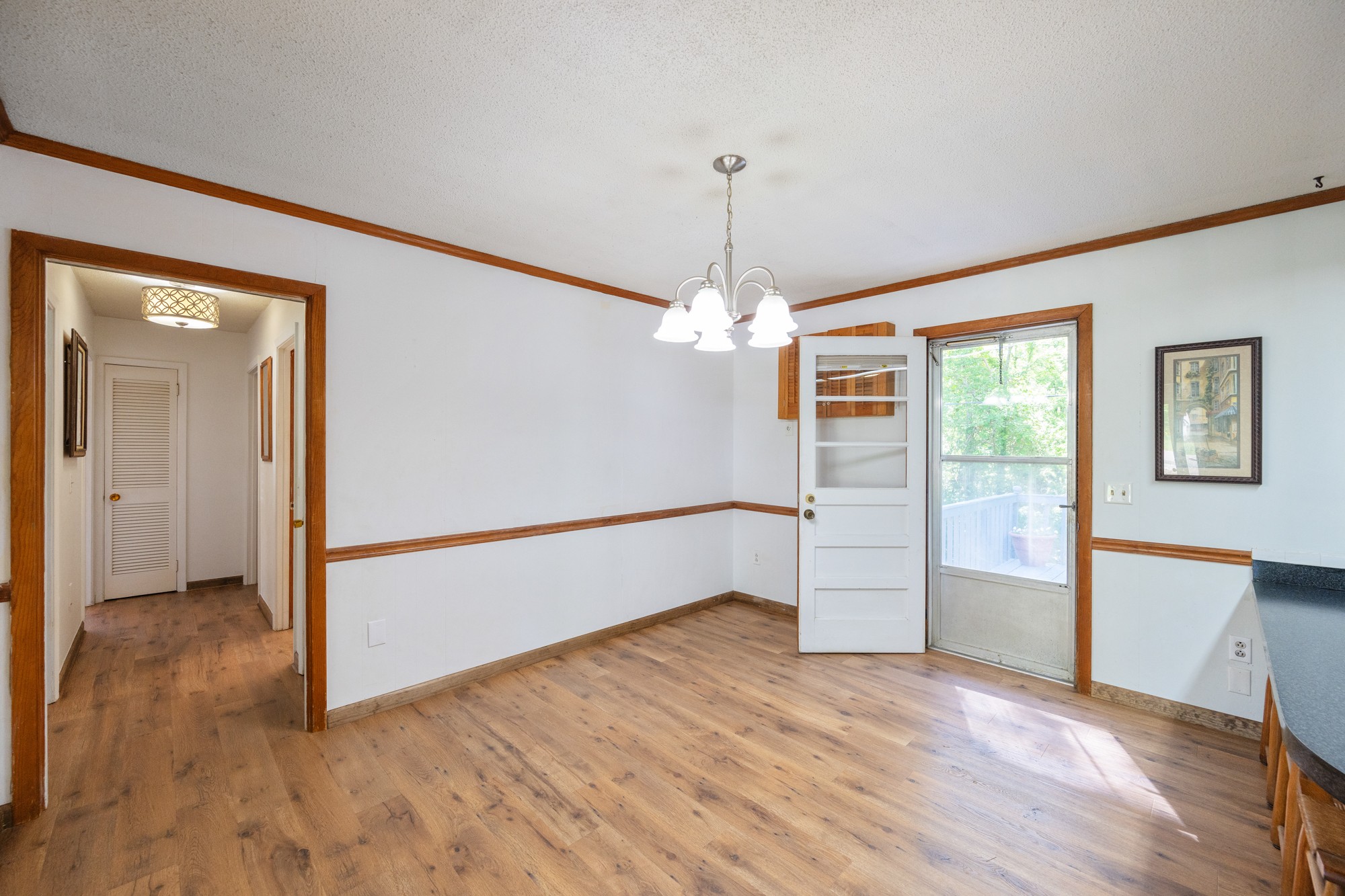 53 Elm Street Decaturville, TN 38329 - Photo 13 of 44 wooden floor in an empty room with a window