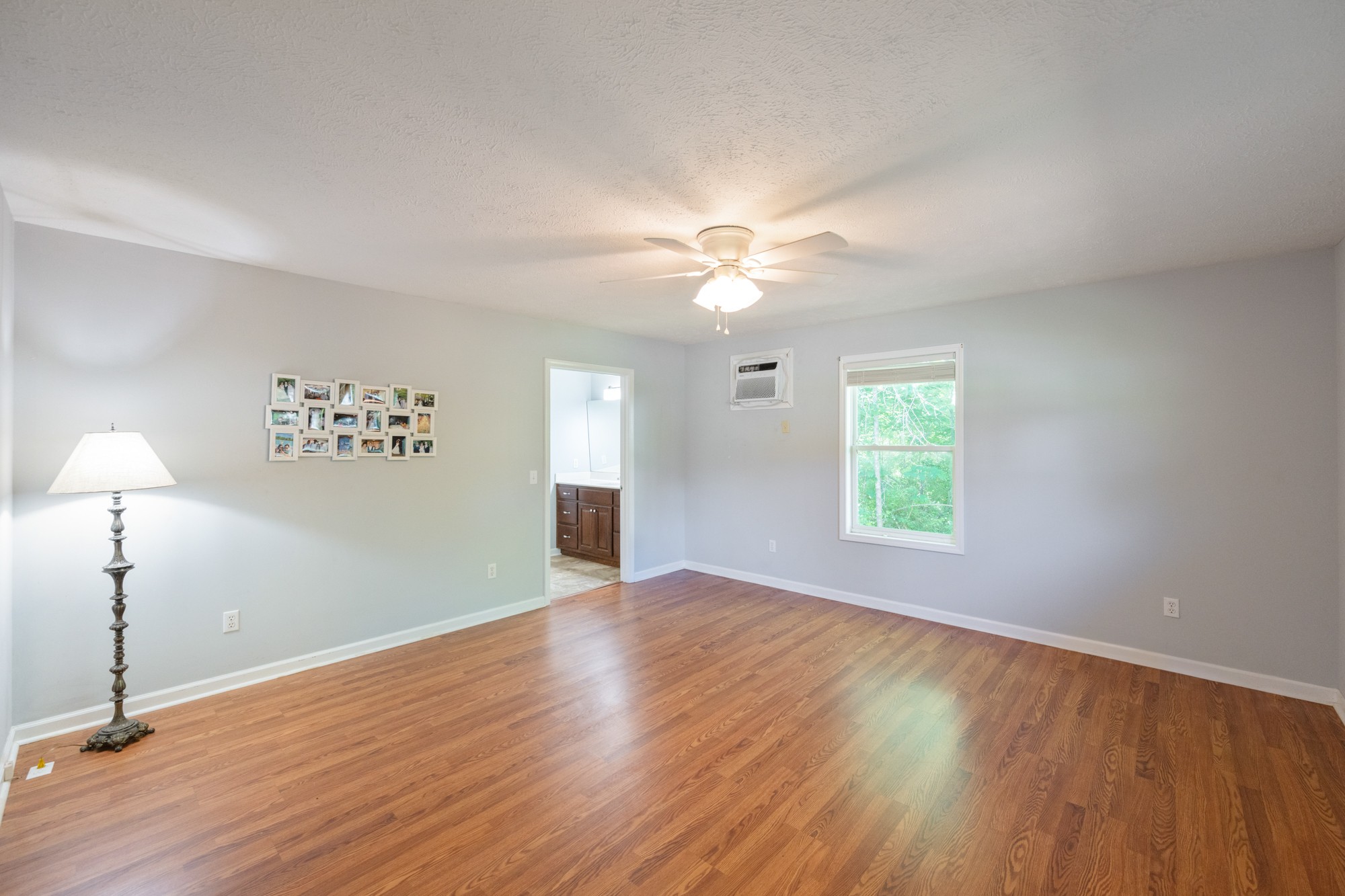 53 Elm Street Decaturville, TN 38329 - Photo 15 of 44 wooden floor in an empty room with a window