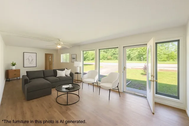 a large kitchen with stainless steel appliances granite countertop a lot of counter space and wooden floors