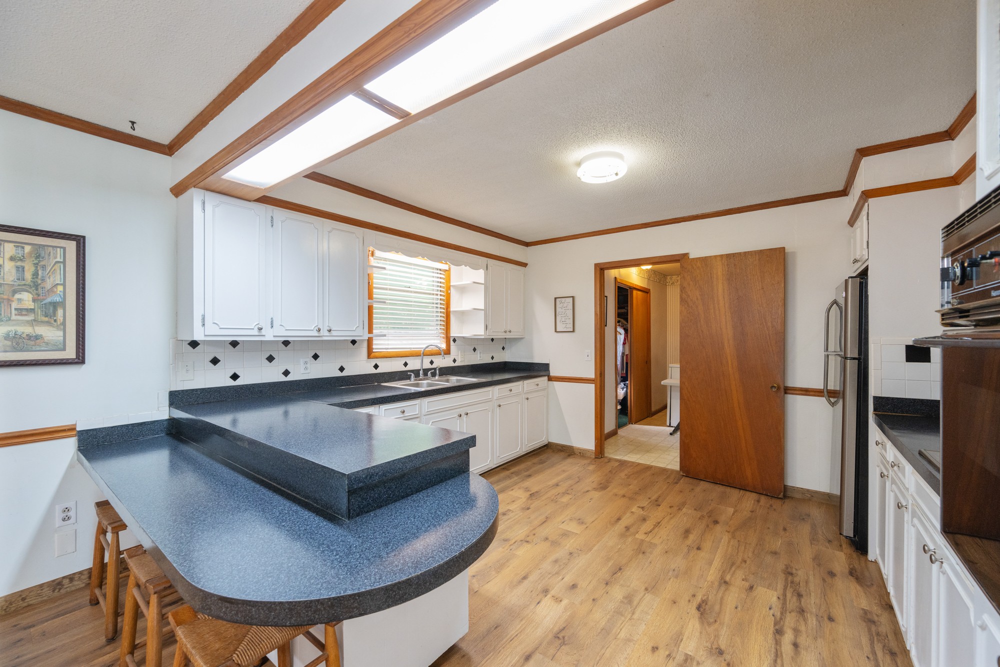 53 Elm Street Decaturville, TN 38329 - Photo 8 of 44 a large kitchen with stainless steel appliances a large counter top a stove a refrigerator and a sink