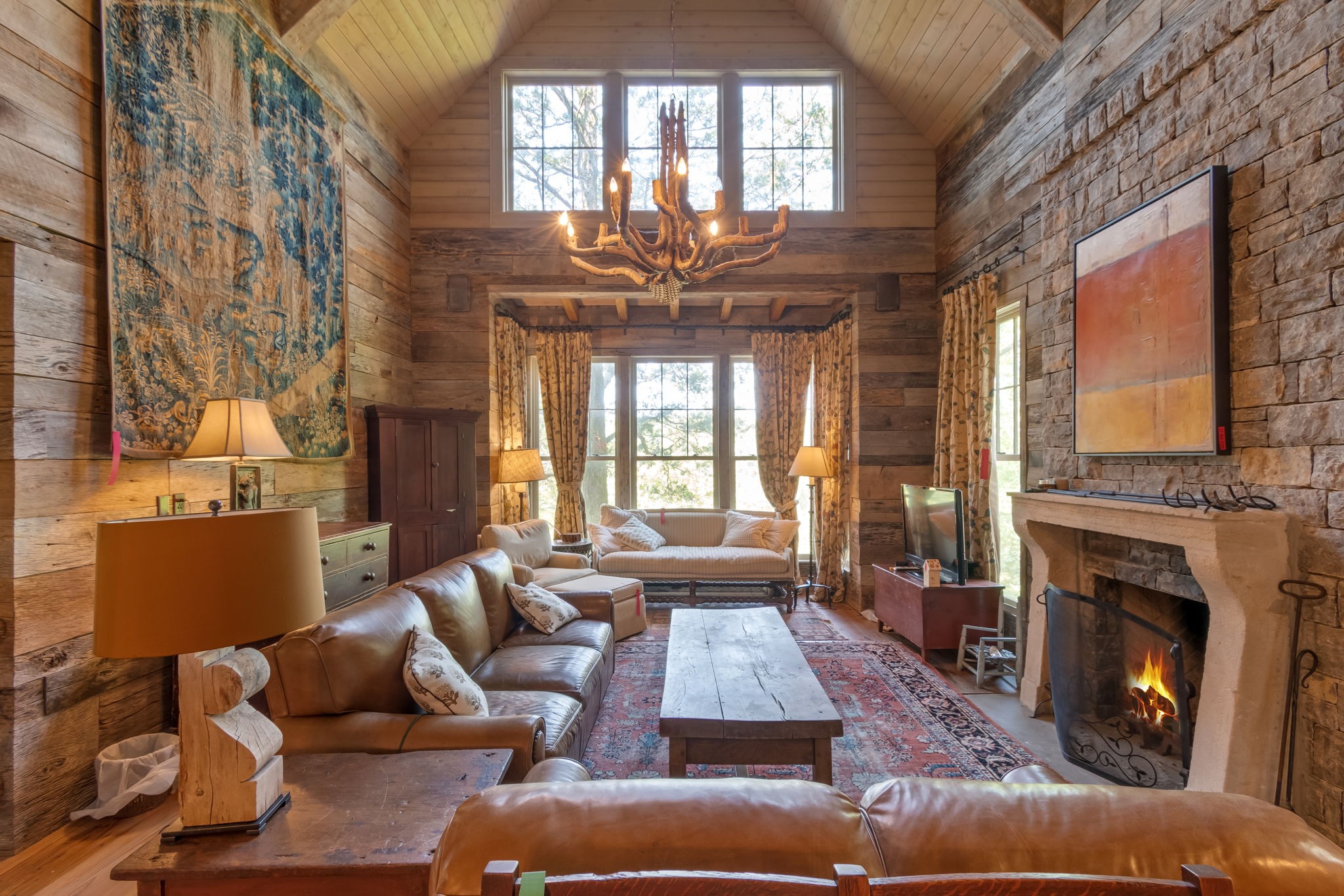 a living room with furniture fireplace and a large window