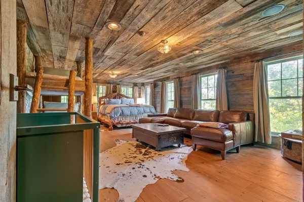 an aerial view of a house with a yard basket ball court and outdoor seating