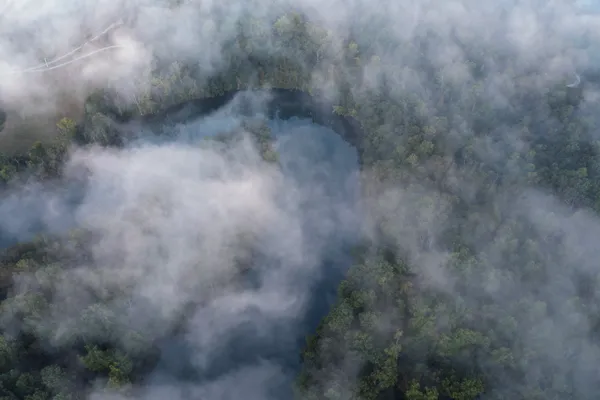 a living room with furniture a fireplace and a table