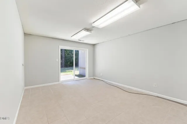 a view of an empty room with a fireplace