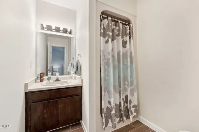 a kitchen that has a kitchen island wooden cabinets and stainless steel appliances