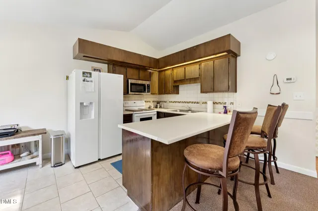 a living room with furniture a large window and a fireplace