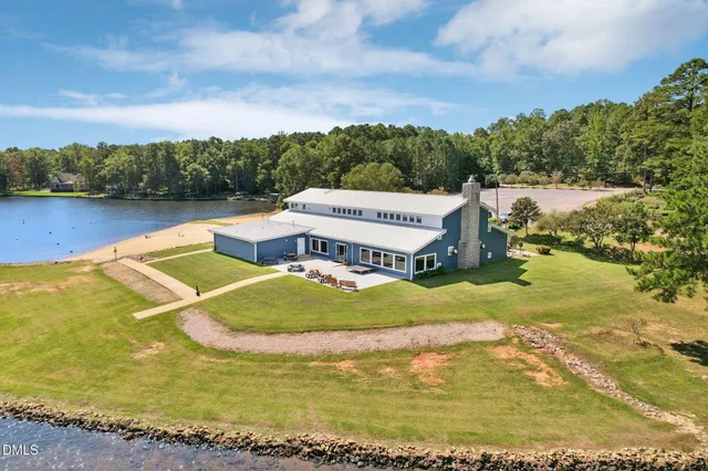 a view of a patio with a table and chairs under an umbrella