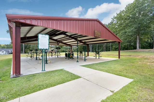 a view of a house with swimming pool and sitting area